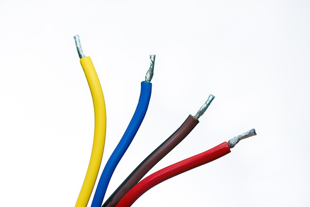 Four electrical wires with yellow, blue, brown, and red coatings