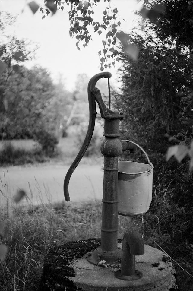 outdoor water faucet with a bucket