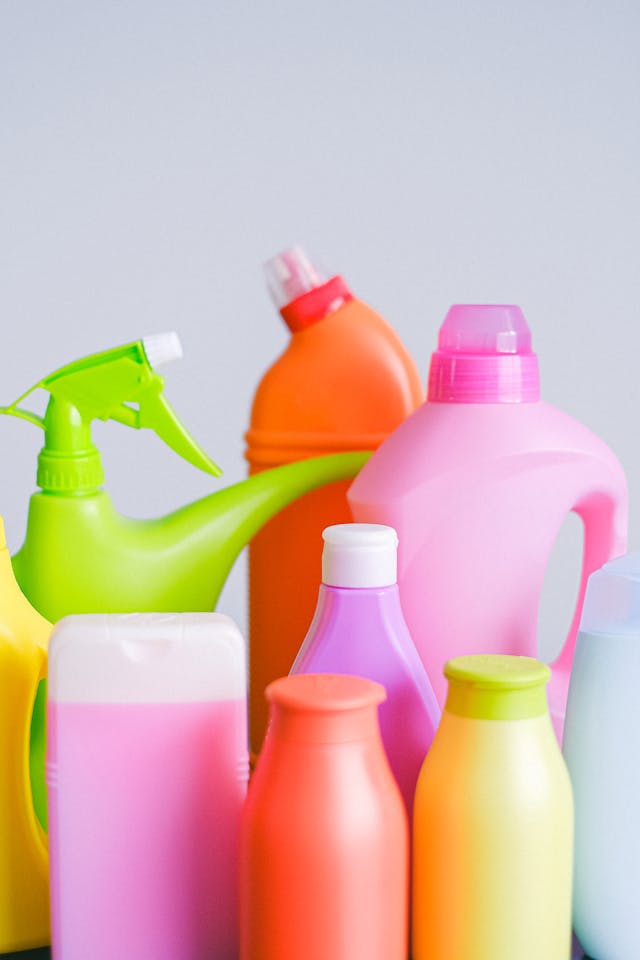 Bottles with cleaning products on table